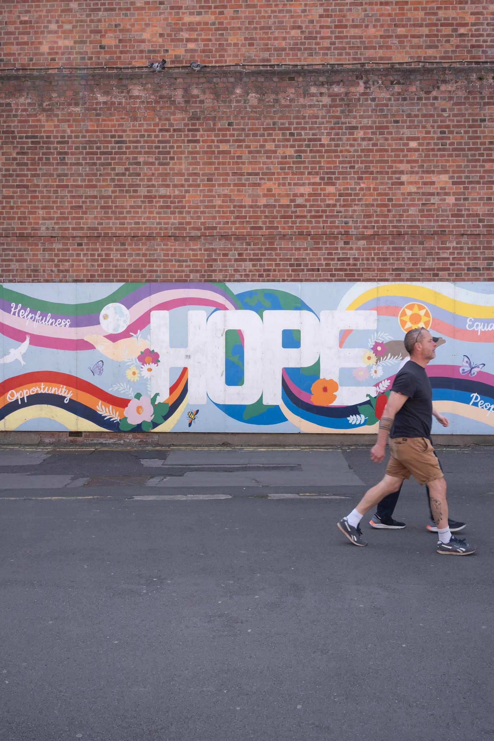 Colourful tropical mural painted on a brick wall