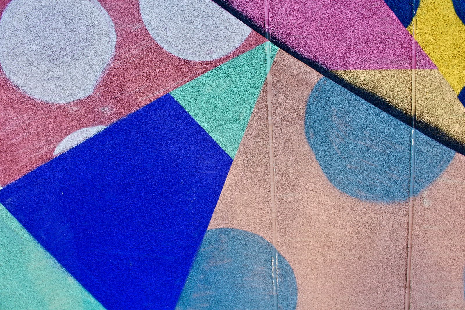 Colourful painted shapes and patterns on a flat surface